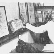 Black and white image of Doris Marshall examining patients' x-rays.